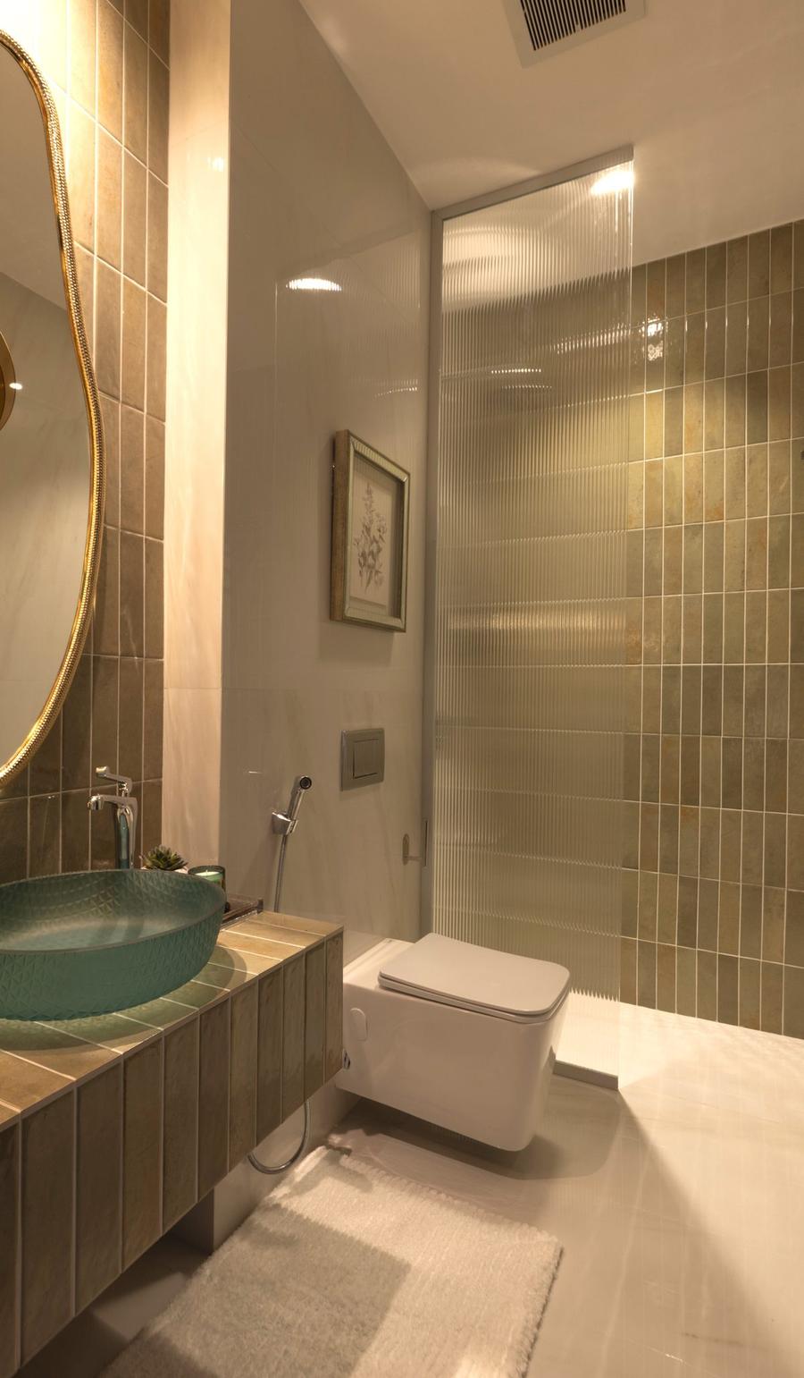 Third bathroom with sea-glass vessel sink and golden tiles